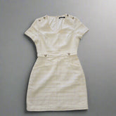 Beige textured dress on a tiled floor